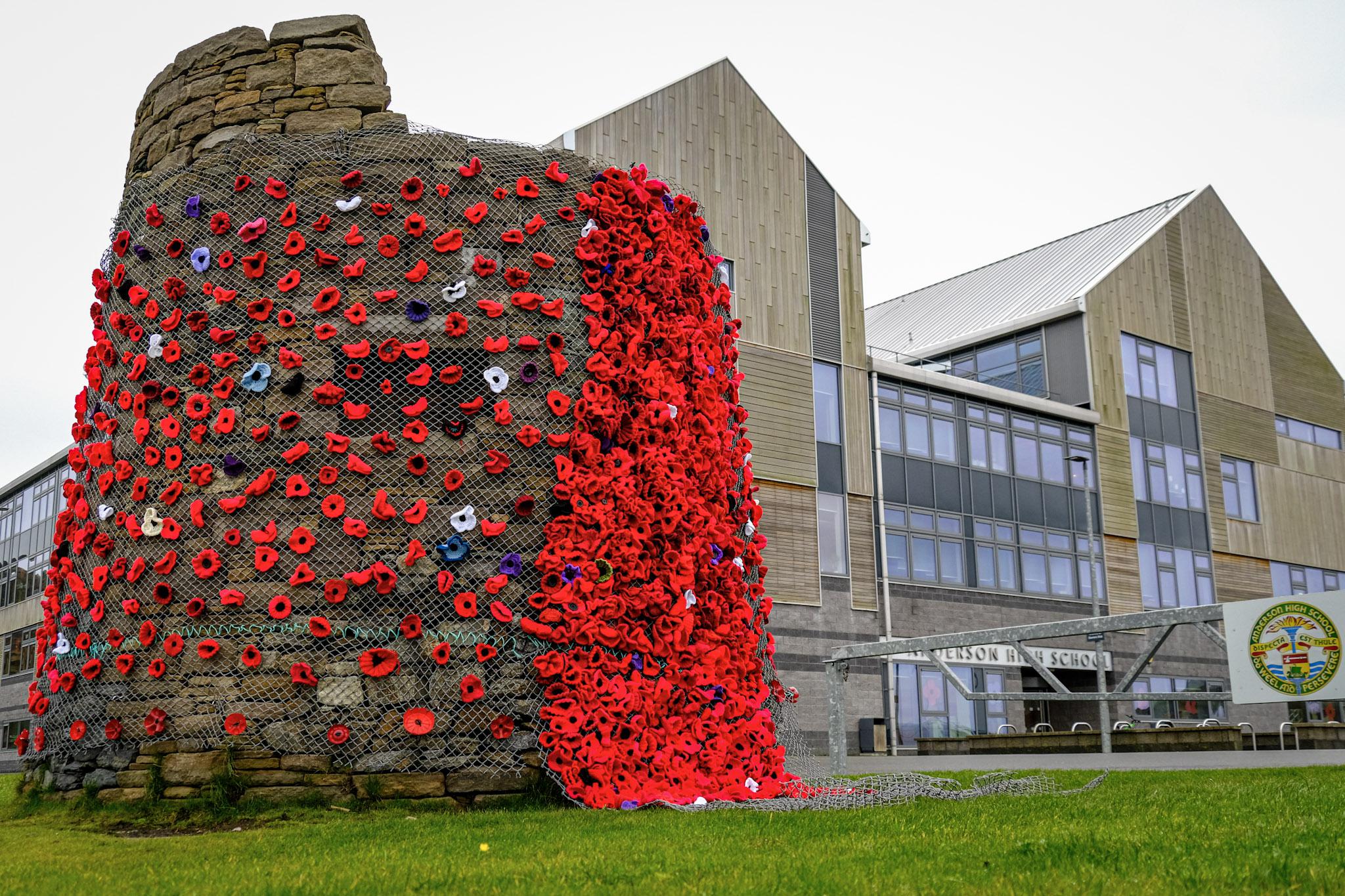 Remembrance poppies on the cairn at Anderson High School, Lerwick.