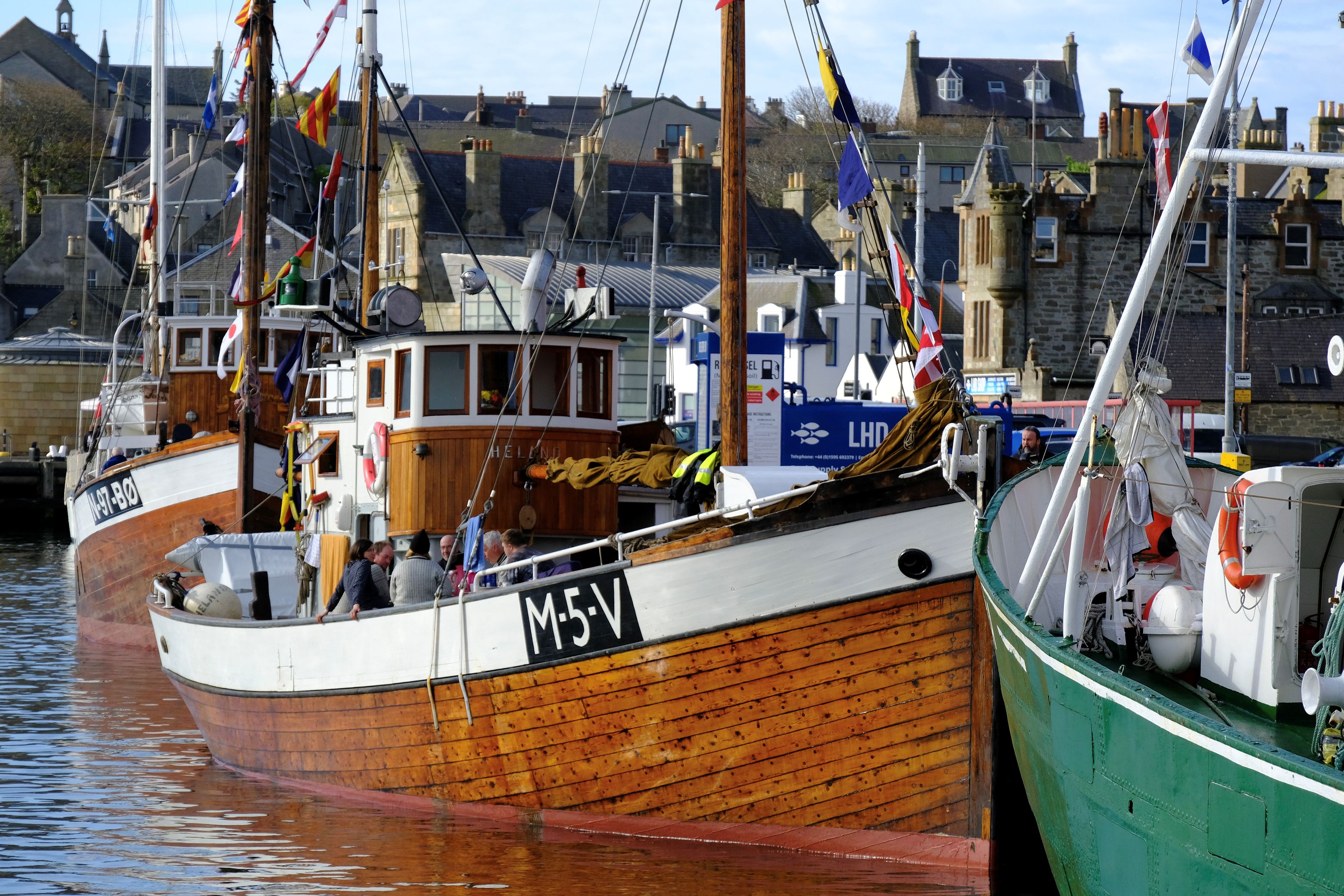 Small convoy boats moored together in the harbour