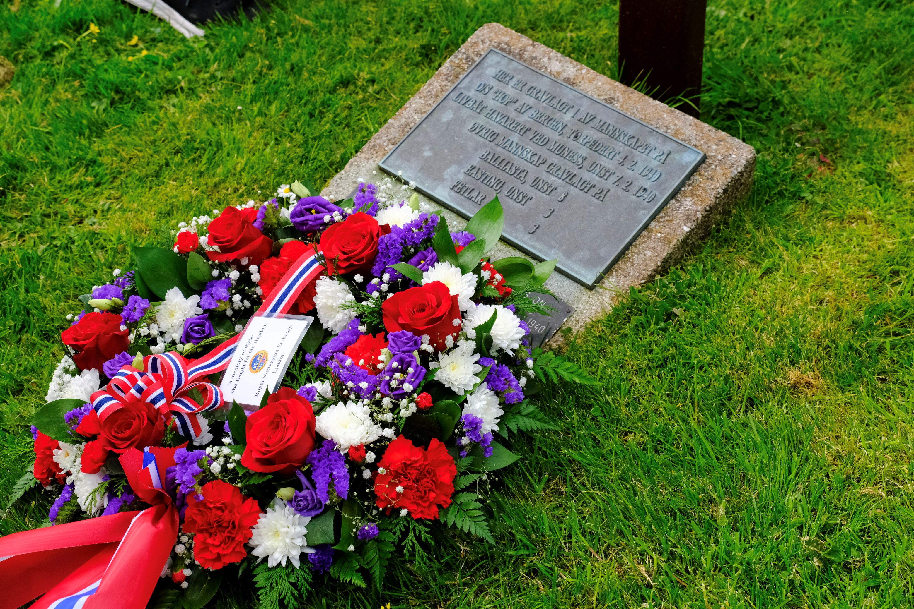 A wreath lies in front of a grave marker