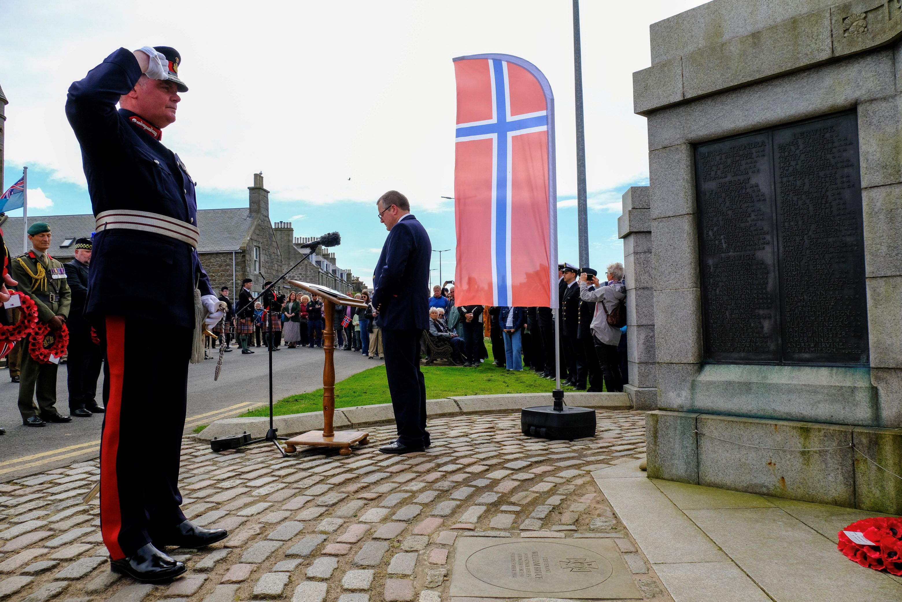 Lord Lieutenant Lindsay Tulloch salutes the memorial after laying a wreath