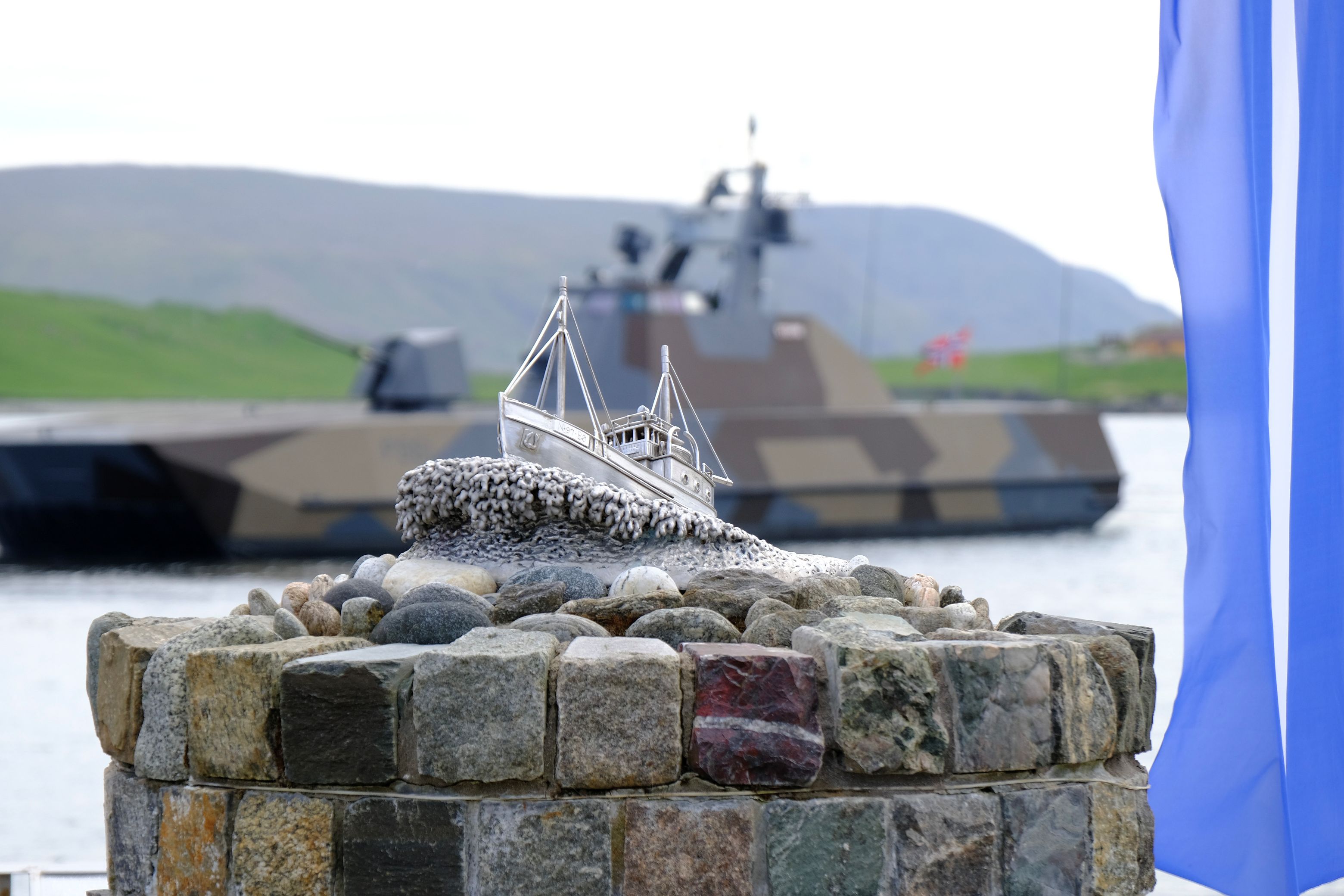 The Shetland Bus Memorial with Norwegian naval vessel behind