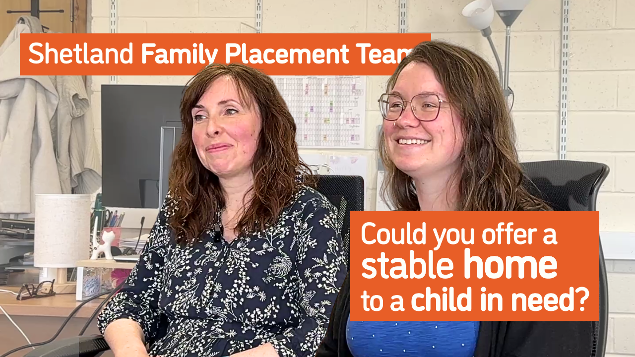 Angela and Elaine sit in an office setting, they're both smiling and animated