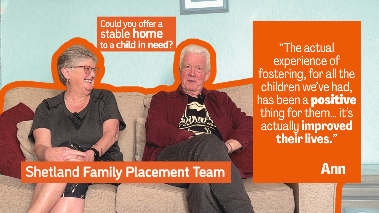 Ann and Ian sit on the sofa - they both look very cheery