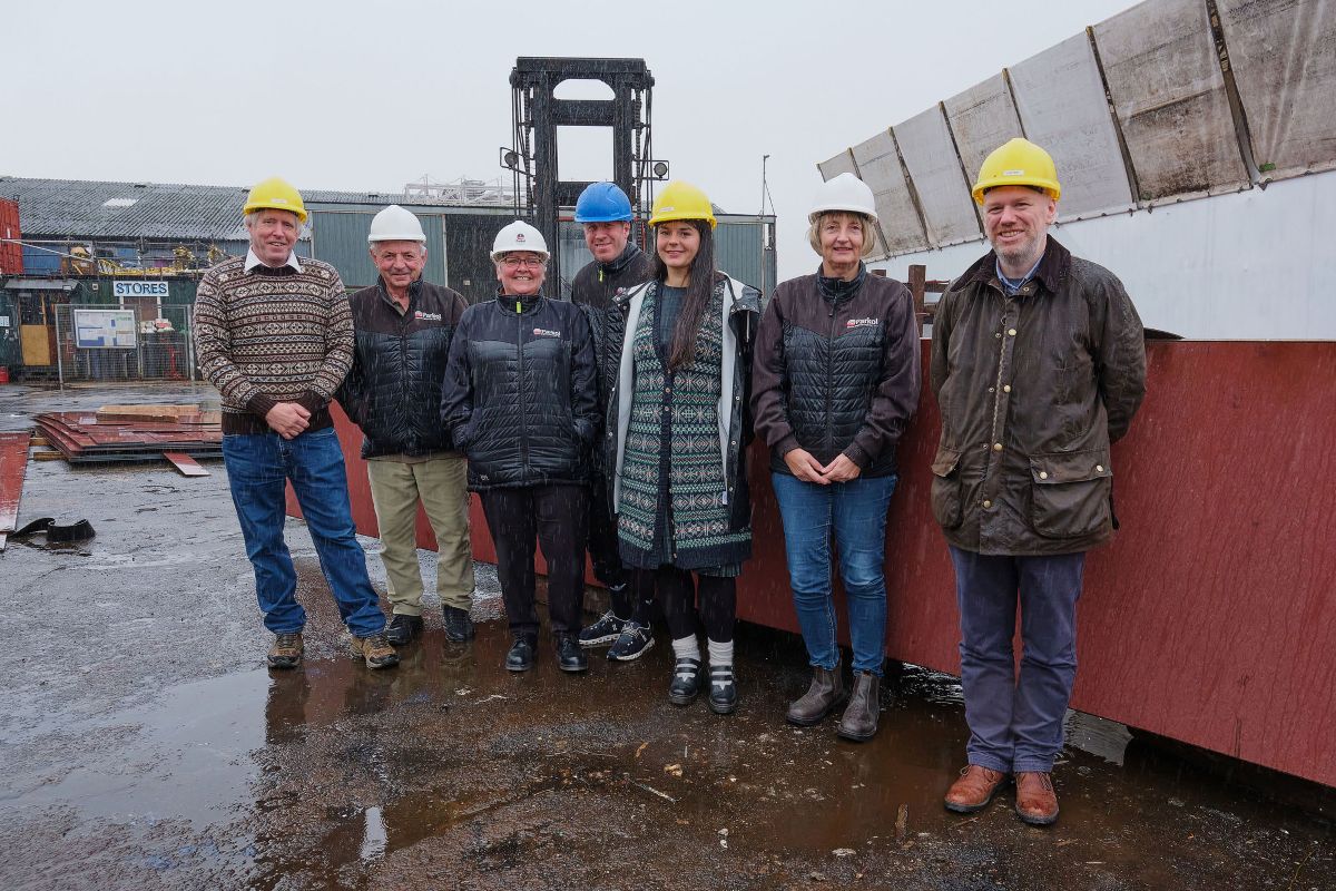 Ian Best (left), Marie Bruhat (fifth from left) and Lee Coutts (right) with Parkol Marine Engineering staff in Whitby, where the new Fair Isle ferry is currently being built.