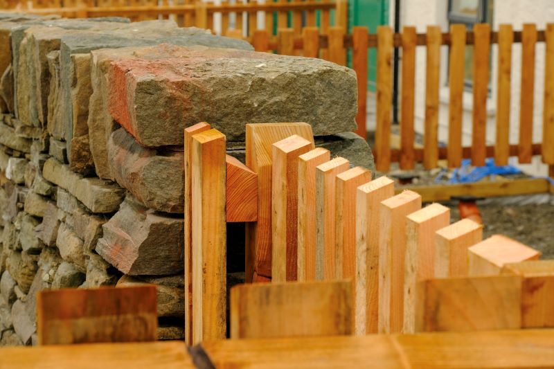 Close up of wooden gate next to stone wall