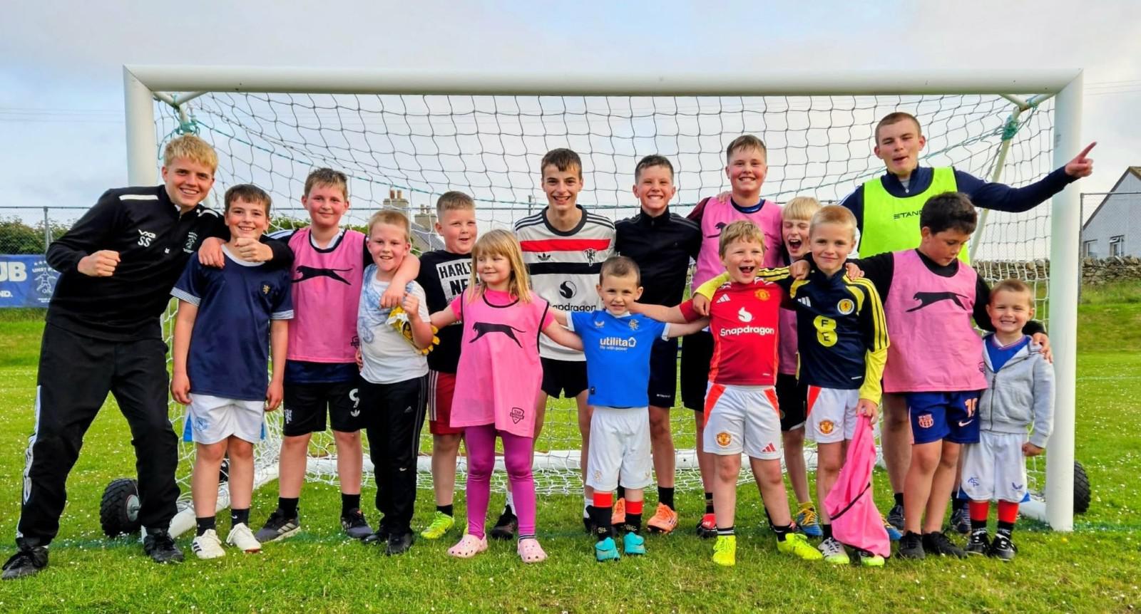 A group photo of Unst bairns enjoying a free football session