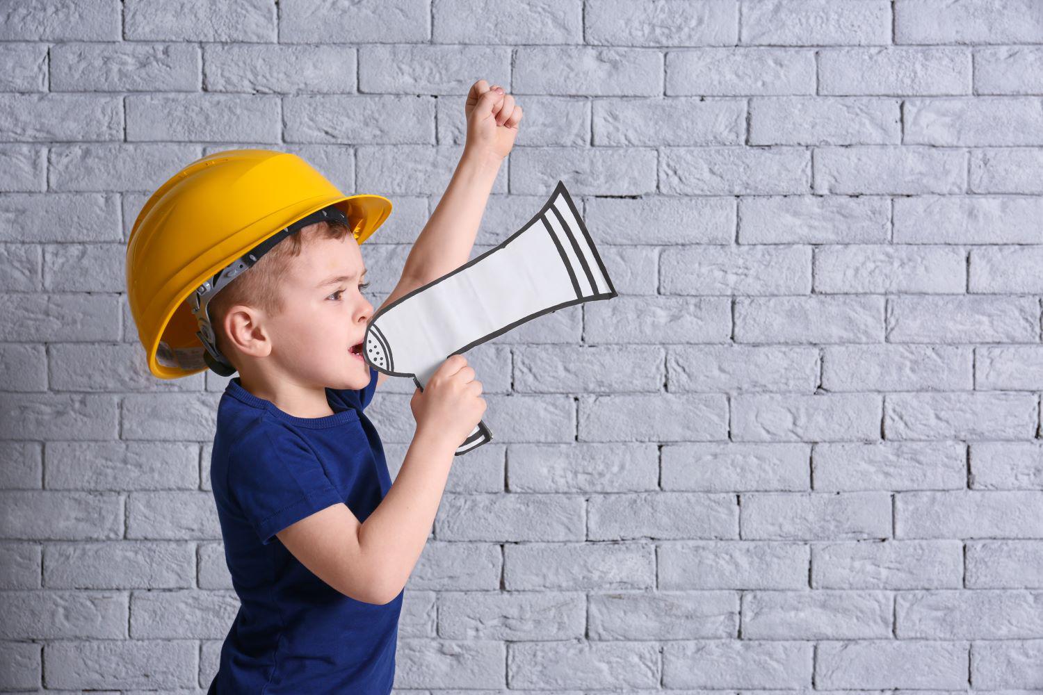 UCRC - boy standing with megaphone.  Credit: Shutterstock